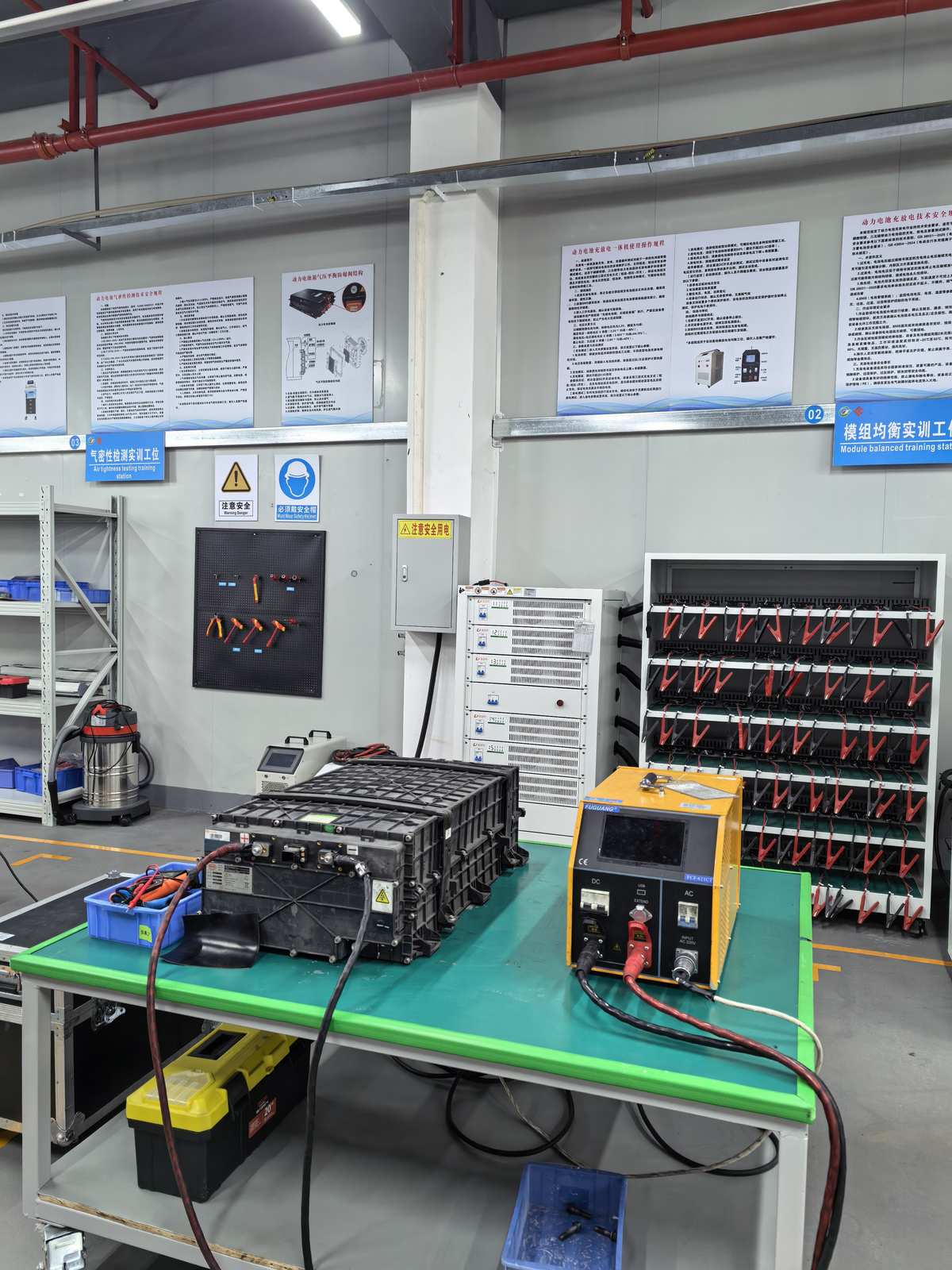 Integrated battery cell balancing, charging and discharging workstation at NEV Fix Guangzhou facility