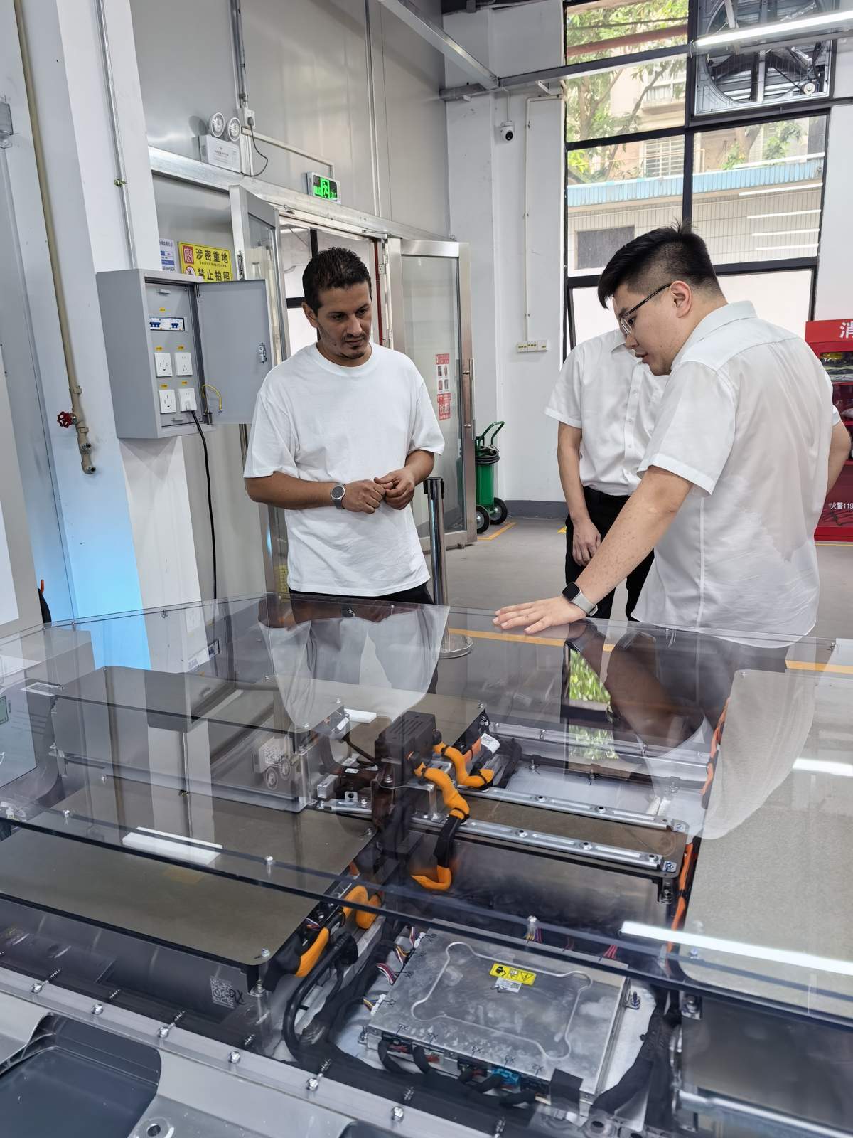 International technician receiving hands-on training on EV battery systems at NEV Fix Guangzhou facility